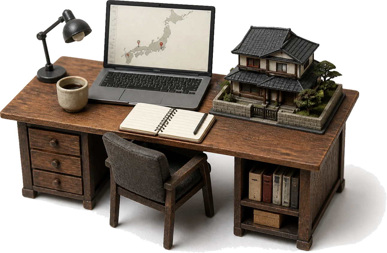 Miniature model of a desk with a laptop showing a map of Japan, a notebook, and a model Japanese house