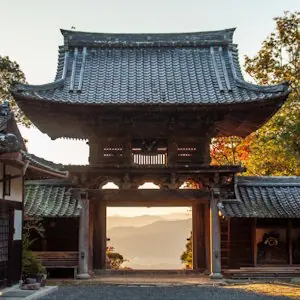 View looking out from the main gate of Tokonagezan Senju-ji Temple over mountains and clouds in the Kameoka Basin, Kyoto.