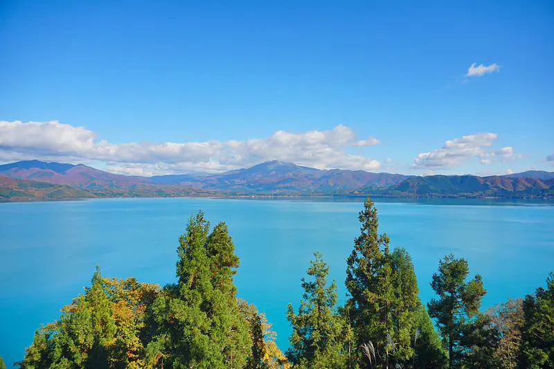 Deep blue Lake Tazawa framed by autumn mountains in Akita Prefecture