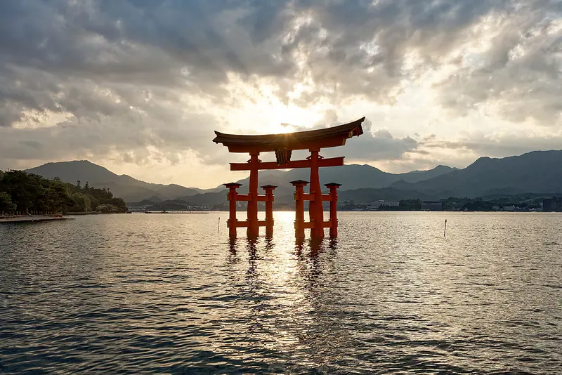 The floating red torii gate of Itsukushima Shrine at sunset on Miyajima, Hiroshima