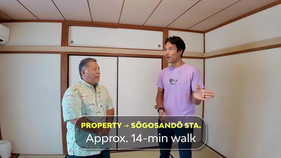 An AkiyaHub team member and a buyer inside a traditional Japanese tatami room reviewing property and station access details