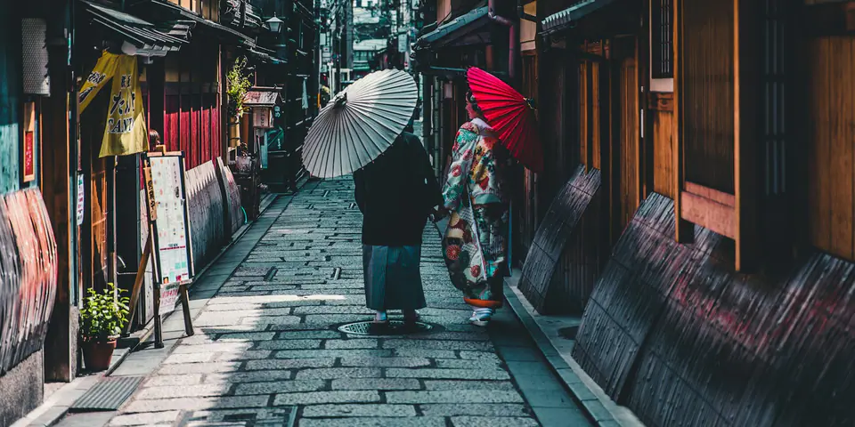 A quiet street of traditional wooden townhouses in Kyoto