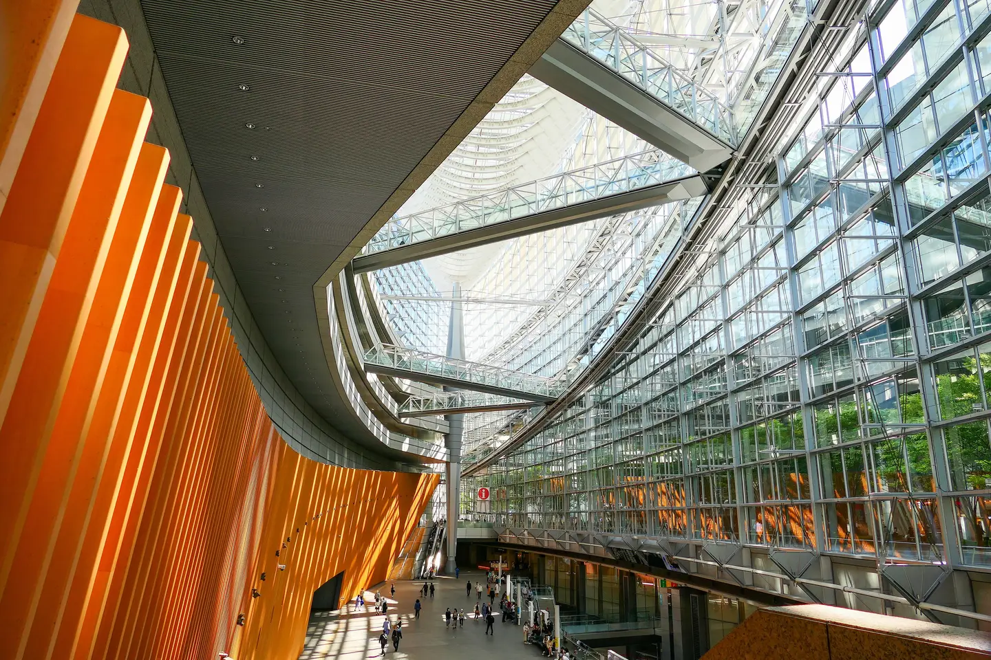 Inside the Glass Building at Tokyo International Forum: the curved timber wall, the glass roof and the walkways above the atrium