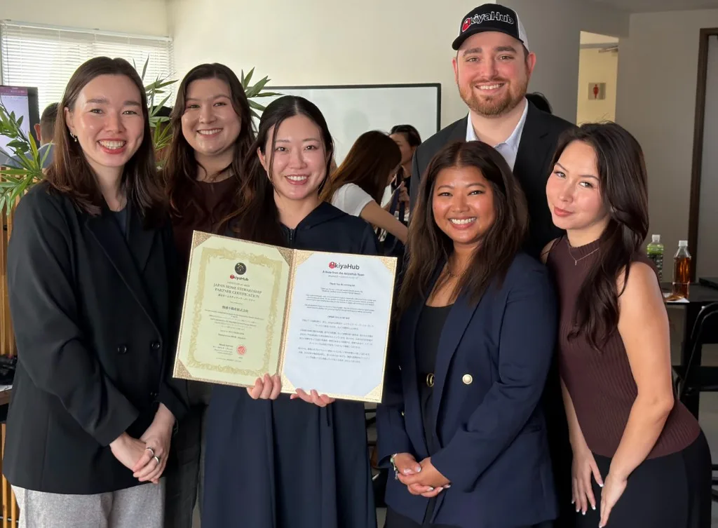 The AkiyaHub team holding a Japan Home Stewardship partner certificate at the program launch