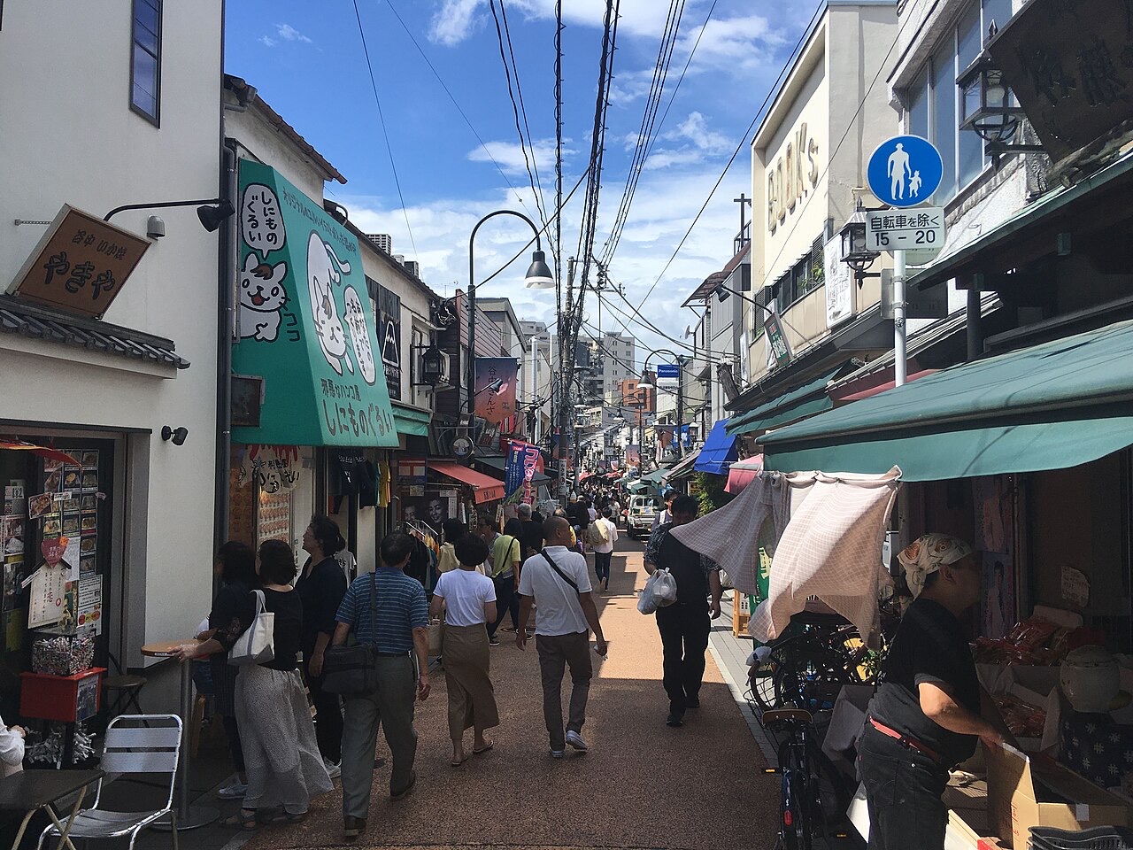 Shoppers walking through the Yanaka Ginza shopping street in Tokyo