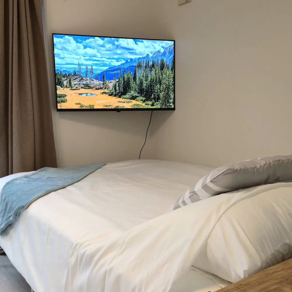Bed, 4K TV, and air conditioner inside JT Terrace House #101