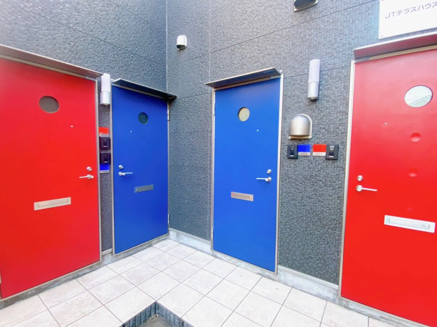 JT Terrace House #101 exterior with colorful front doors